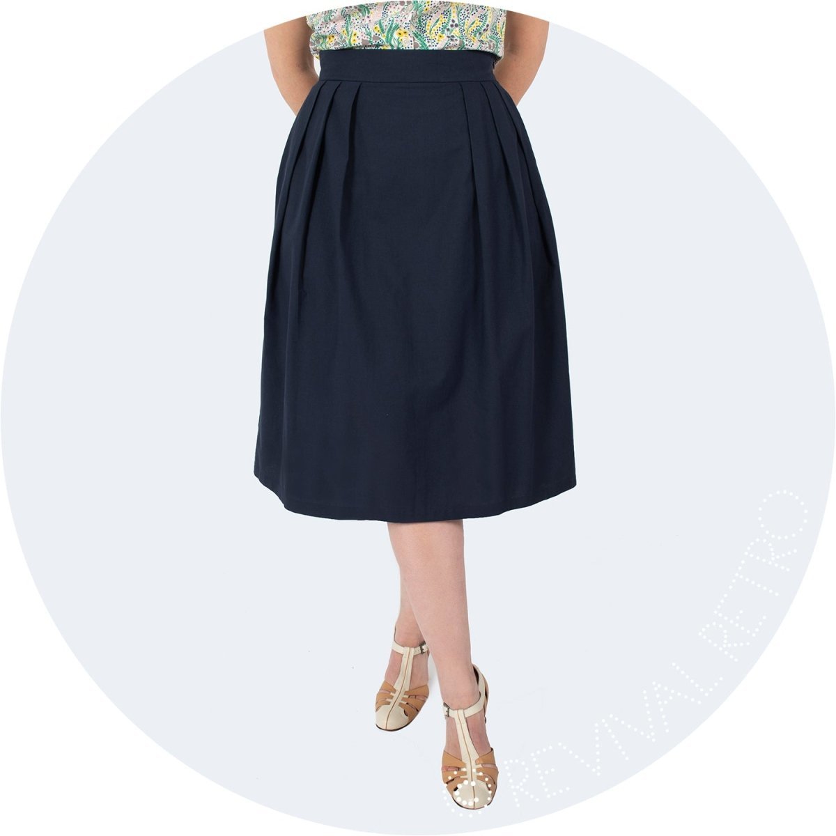 Organic cotton A-line skirt in navy with deep pleats at the sides.