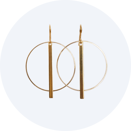 Deco inspired earrings made of brass and featuring a circle with a bar slightly longer than the circle hanging from the centre top.