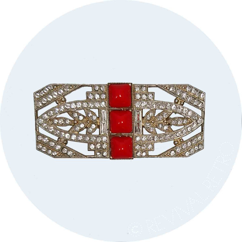 Art Deco rectangular brooch featuring red stones in the centre and diamante detailing 