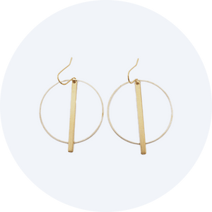 Deco inspired earrings made of brass and featuring a circle with a bar slightly longer than the circle hanging from the centre top.