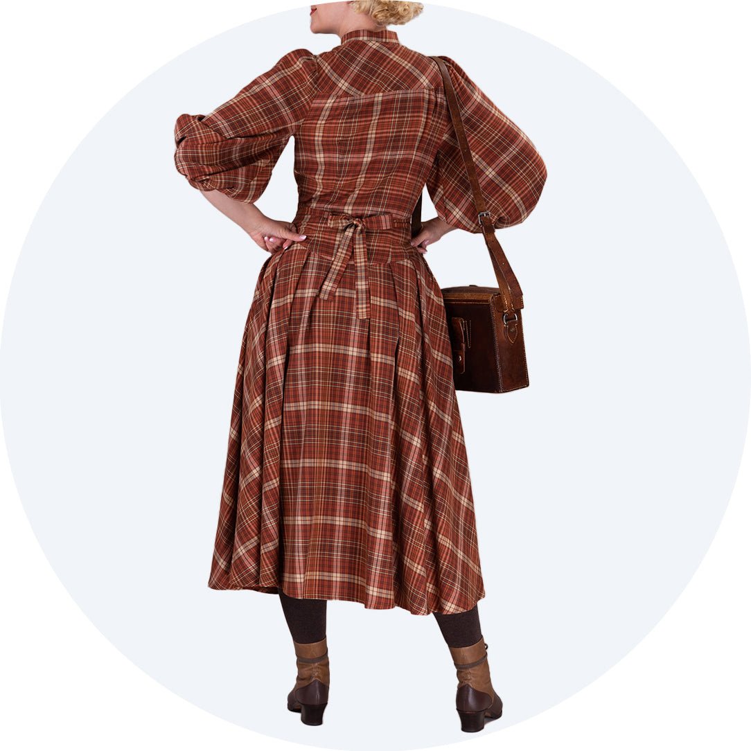 Vintage style dress with three quarter sleeves, yoke, tie belt and dropped waist as seen from behind- The Green Gables Dress by Emmy Design Sweden in rusty plaid from Revival Retro London UK
