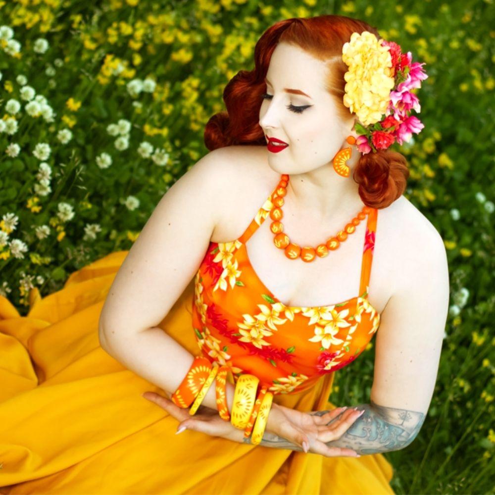 Vintage Model poses wearing bakelite style bangles in yellow and orange