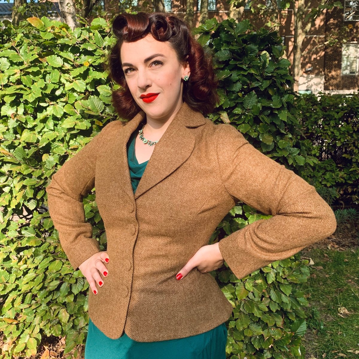 Suit jacket for curvy women, seen here worn over a green vintage style dress