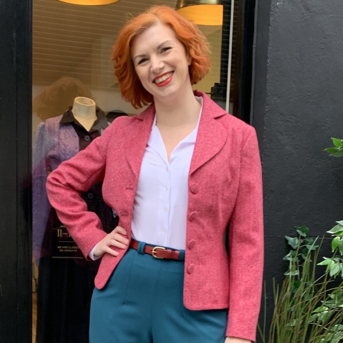 Jacket to fit bigger bust on a curvy shape white woman with ginger hair who poses with one hand on hip